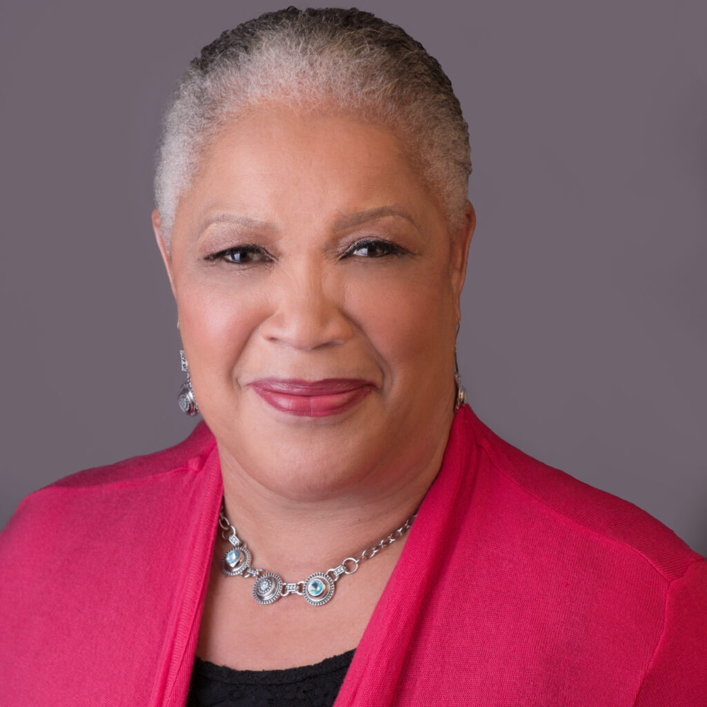 A woman in a pink jacket and black shirt